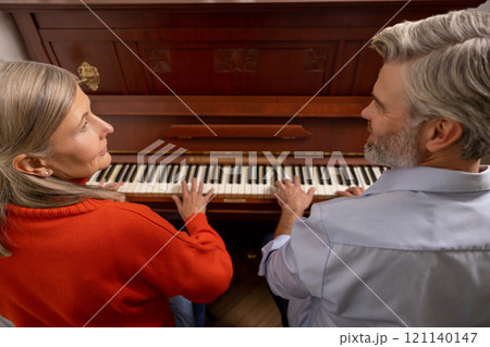 Mature woman having a music class with a male teacher 121140147