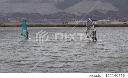 A kite surfer rides and jumps the waves the black sea 121140256