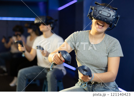 girl in virtual reality glasses controls superhero with joystick in exciting action game simulator girl in virtual reality glasses controls superhero with joystick in exciting action game simulator 121140423
