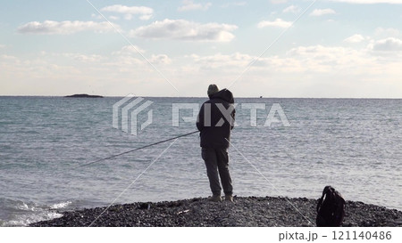 Many fishermen catch mullet fish on a spinning rod on the sea coast 121140486