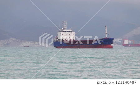 Sea freighter sailing in the middle of the ocean with big waves Sea freighter sailing in the middle of the ocean with big waves 121140487
