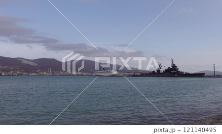 Novorossiysk, Russia - 18 August 2024 Cruiser Mikhail Kutuzov and dolphins, Black Sea, port, Krasnodar Territory, Novorossiysk. Novorossiysk, Russia - 18 August 2024 Cruiser Mikhail Kutuzov and dolphins, Black Sea, port, Krasnodar Territory, Novorossiysk. 121140495