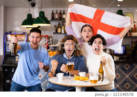 Group of people with England flag toasting with beer, having fun at party in nightclub Group of people with England flag toasting with beer, having fun at party in nightclub 121140576