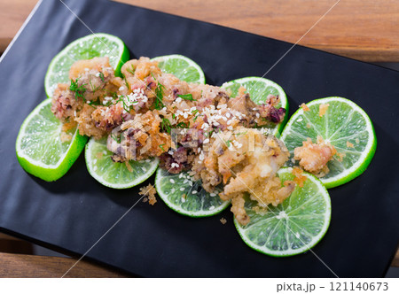Battered calamari and cuttle with lime Battered calamari and cuttle with lime 121140673