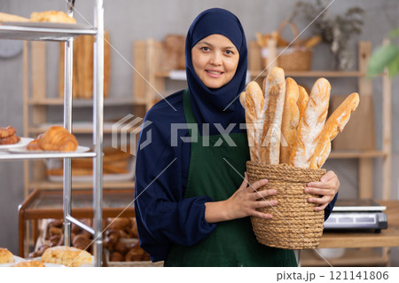 Muslim seller holding bread 121141806