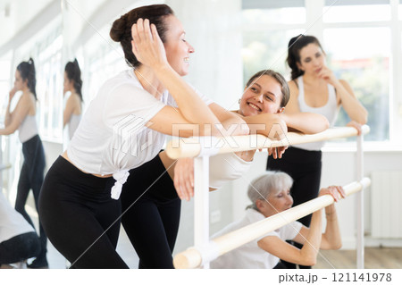 Enthusiastic female ballet learners cooling down and socializing Enthusiastic female ballet learners cooling down and socializing 121141978