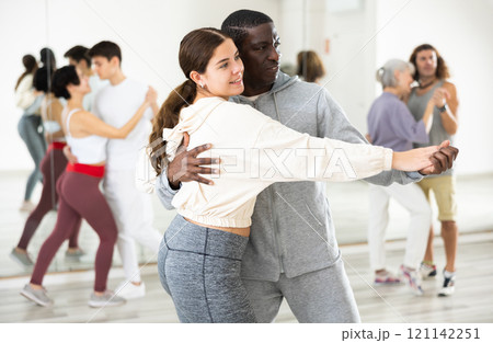 Positive couple of dancers learns a slow foxtrot 121142251