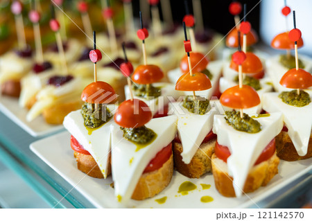 Pincho with feta tomato and pesto sauce Pincho with feta tomato and pesto sauce 121142570