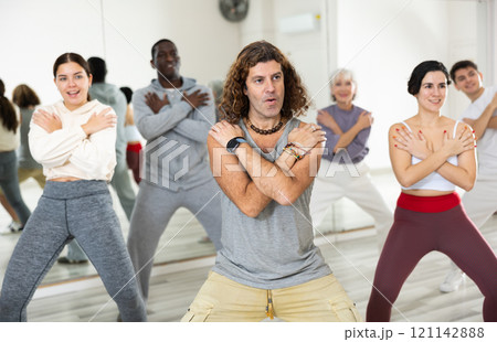Smiling adults of different nationalities train movements in jazz dance Smiling adults of different nationalities train movements in jazz dance 121142888