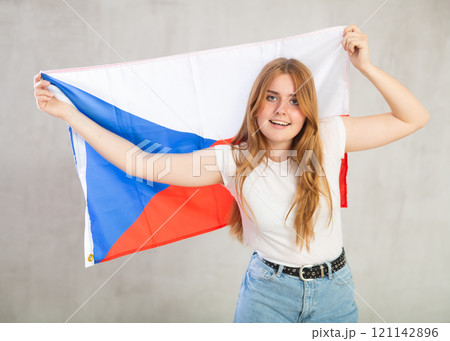 smiling girl in arms raised above head holds cloth of national flag of Czechia smiling girl in arms raised above head holds cloth of national flag of Czechia 121142896