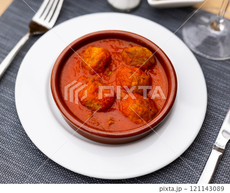 Appetizing meatballs with tomato sauce served on platter 121143089