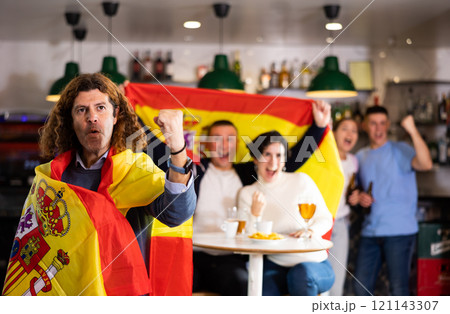 Happy fans celebrating the victory of Spanish team in bar Happy fans celebrating the victory of Spanish team in bar 121143307