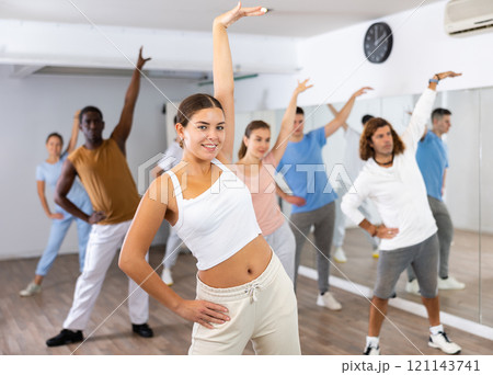 Group of different people rehearsing dance in dance studio 121143741