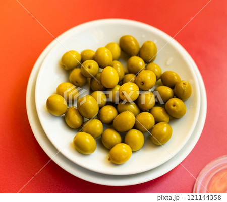 Light snack - bowl with pickled green olives 121144358