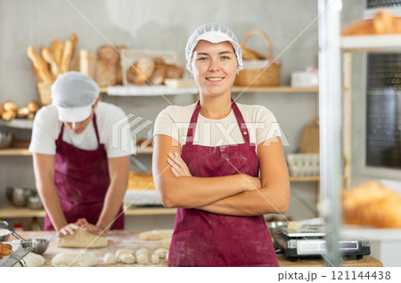 Young girl standing in bakehouse, ready to start baking 121144438