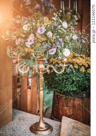 Wooden wedding interior reastaurant decoration with flowers and candles Wooden wedding interior reastaurant decoration with flowers and candles 121146070