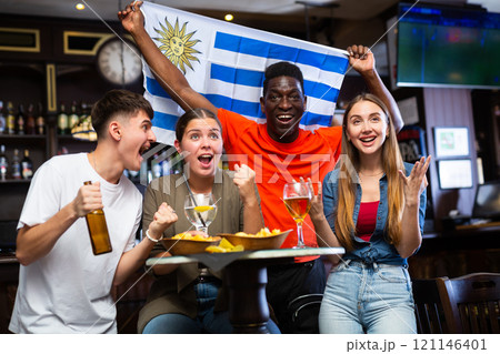 Group of Uruguay football team fans spending time in bar 121146401