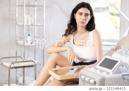 woman gazes at herself in mirror woman gazes at herself in mirror 121146421