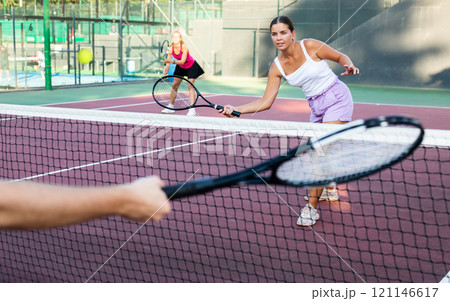 Focused young woman playing friendly tennis match. Concept of concentration in competition 121146617