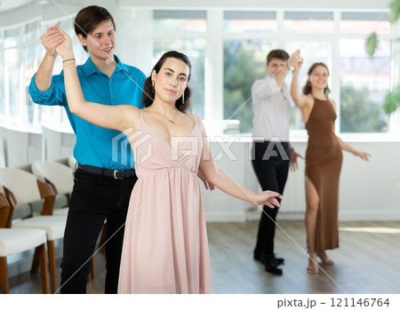 During rehearsal, guy and girl participants of dance workshop perform social pair dance During rehearsal, guy and girl participants of dance workshop perform social pair dance 121146764