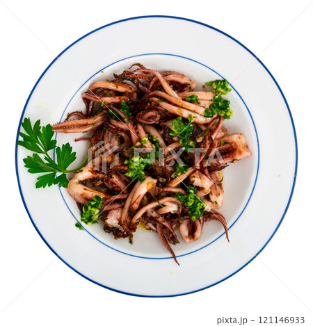 Seafood lunch. Tasty squid or octopus tentacles closeup 121146933
