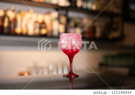 Refreshing cocktail tequila sunrise with tequila, orange juice and grenadine syru, cold drink with ice 121146934