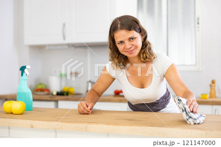 Woman housewife cleaning furniture at home kitchen Woman housewife cleaning furniture at home kitchen 121147000