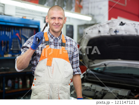 Professional auto mechanic posing in workshop Professional auto mechanic posing in workshop 121147121