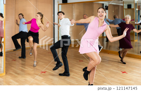 Young pair practicing Latino dance in dance studio 121147145