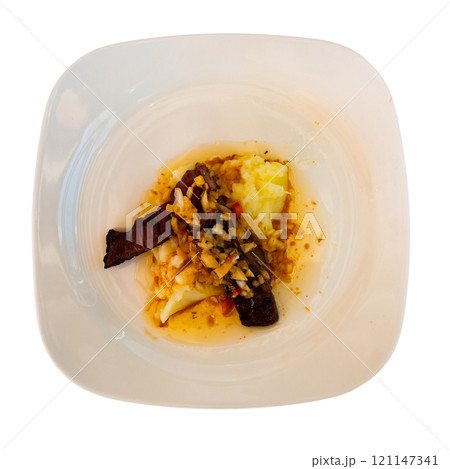 Dish of day from chef of restaurant is beef jerky with Creole sauce, garnished with mashed potatoes 121147341