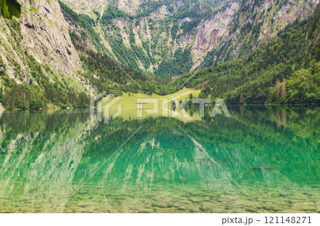 Konigssee Lake in Bavaria Germany with Church by the Lake White Boat Forested Mountain and Beautiful Sunny Trekking in Berchtesgaden German Alps. High quality photo Konigssee Lake in Bavaria Germany with Church by the Lake White Boat Forested Mountain and Beautiful Sunny Trekking in Berchtesgaden German Alps. High quality photo 121148271