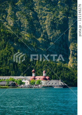 Konigssee Lake in Bavaria Germany with Church by the Lake White Boat Forested Mountain and Beautiful Sunny Trekking in Berchtesgaden German Alps. High quality photo Konigssee Lake in Bavaria Germany with Church by the Lake White Boat Forested Mountain and Beautiful Sunny Trekking in Berchtesgaden German Alps. High quality photo 121148276