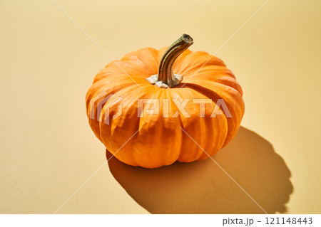 Decorative pumpkin on a yellow background. 121148443