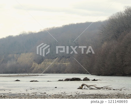 beautiful autumn landscape with clear river and rocky banks, late autumn on mountain river with curved snag lying in water beautiful autumn landscape with clear river and rocky banks, late autumn on mountain river with curved snag lying in water 121148693