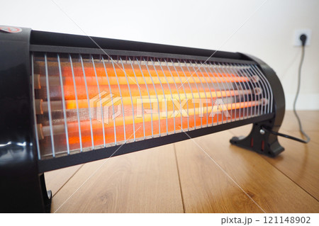 Modern electric infrared heater in living room, closeup 121148902