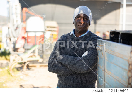 Male tractor driver in farm backyard Male tractor driver in farm backyard 121149605