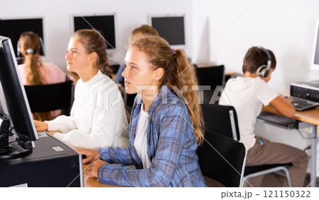 Portrait of female and male students working on computers in class room 121150322