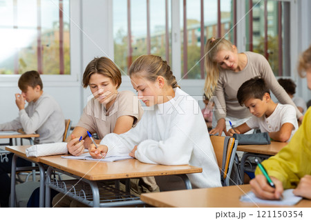 Group of school kids and teacher during lesson Group of school kids and teacher during lesson 121150354