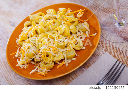 Small appetizing ravioli with cheese on the table Small appetizing ravioli with cheese on the table 121150455