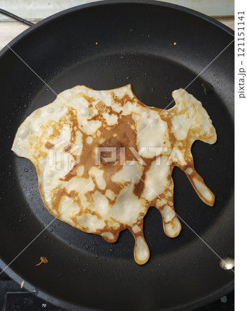 Funny crooked pancake flatbread in a pan Funny crooked pancake flatbread in a pan 121151141