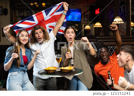United Kingdom sports fans supporting their favourite team in pub 121151241