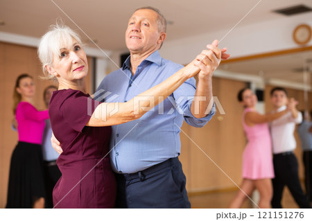 Senior couple dancing slow ballroom dance in choreography studio Senior couple dancing slow ballroom dance in choreography studio 121151276