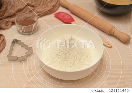 Christmas homemade baking, ingredients for baking gingerbread, sifted flour in a white bowl 121151449