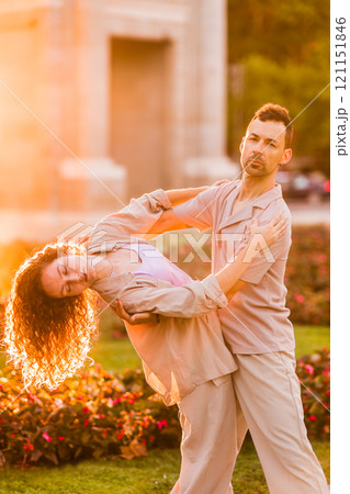 Couple dancing swing in madrid near puerta de alcala at sunset Couple dancing swing in madrid near puerta de alcala at sunset 121151846