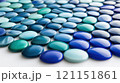 Blue and turquoise glass pebbles arranged in a pattern create a soothing visual effect, AI 121151861