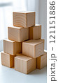 Wooden blocks stacked in a pyramid shape on a white surface, showcasing natural wood grain, AI 121151886