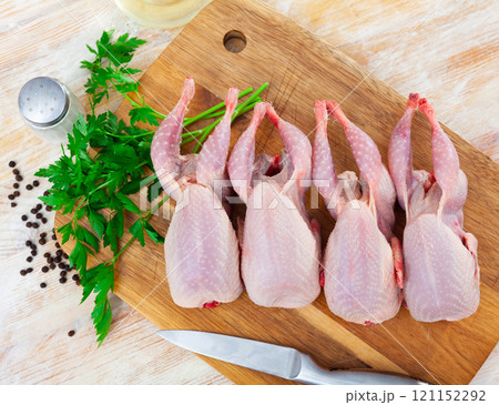 Raw quails on wooden cutting board 121152292