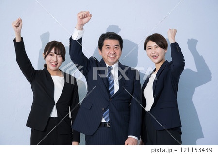 ビジネススーツで複数の成功してガッツポーズや頑張るイメージのカメラ目線　水色背景 121153439