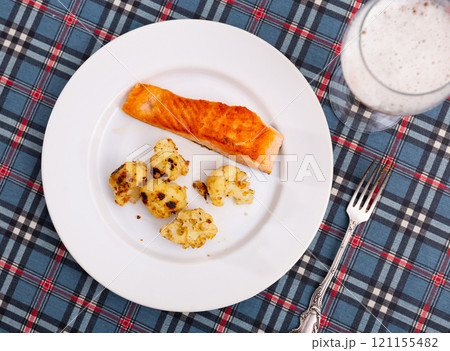 Salmon with cauliflower on a white plate 121155482