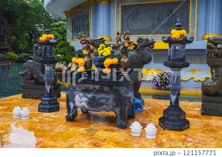 The Asian altar, with colorful floral arrangements on the territory of the Vietnamese temple, symbolizes devotion and spirituality The Asian altar, with colorful floral arrangements on the territory of the Vietnamese temple, symbolizes devotion and spirituality 121157771